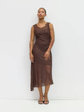Woman wearing a brown lace dress against a white background