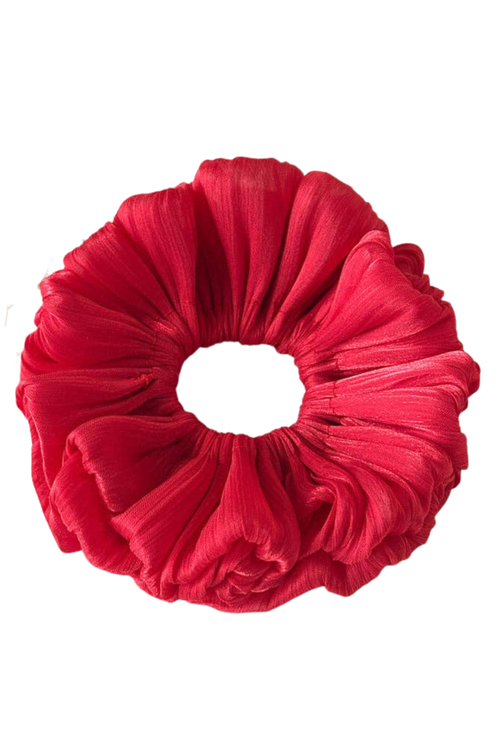 A single bright red fabric hair scrunchie with a textured, crinkled material, shown against a plain white background.