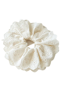 An off-white lace hair scrunchie with delicate eyelet embroidery and scalloped edges, shown against a plain white background.